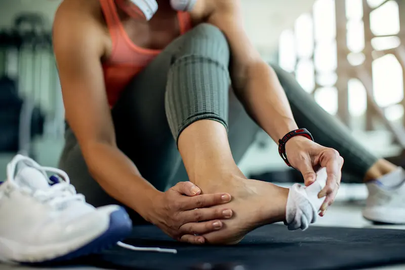 closeup-athletic-woman-injured-her-foot-workout-gym